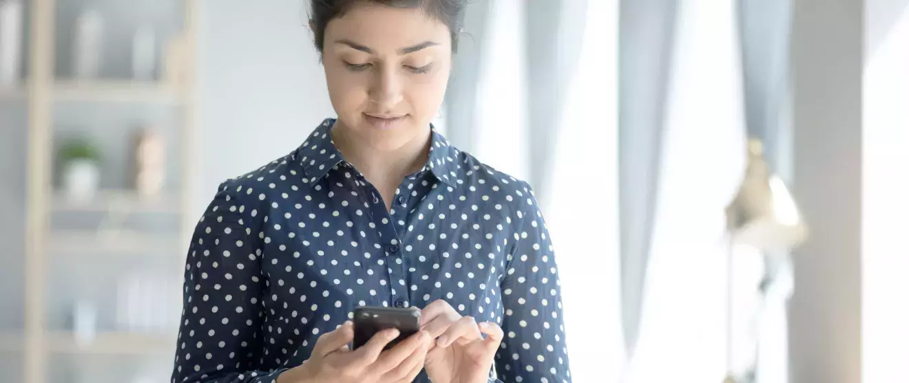 Woman working from home on her smartphone